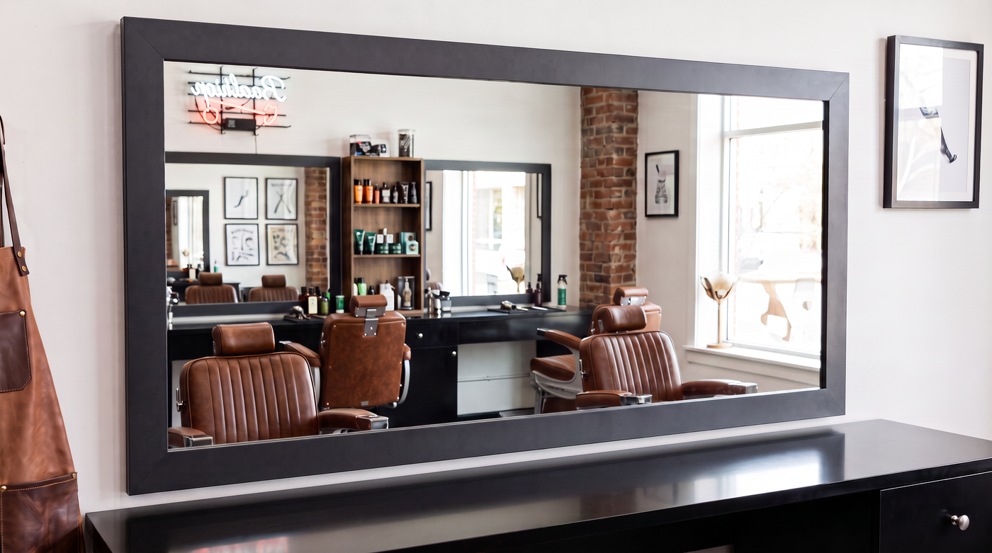 Existing commercial wall mirror upgraded with a made-to-order frame