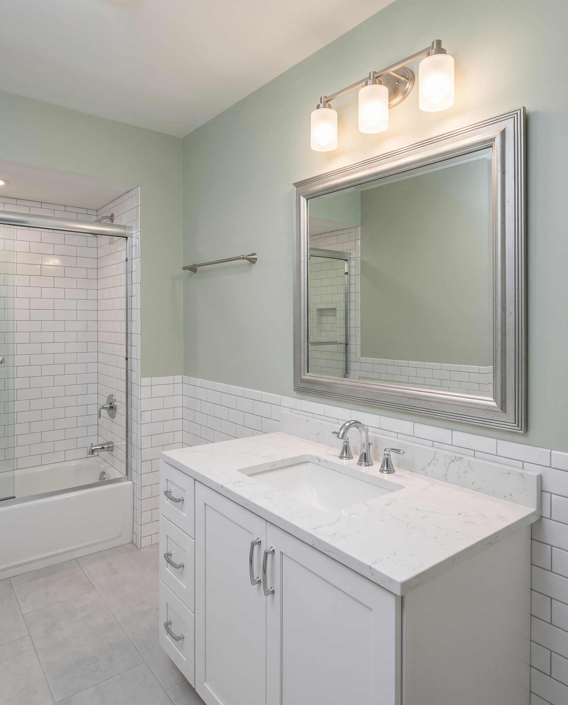 Renovated bathroom with a professionally installed Carson Black framed mirror