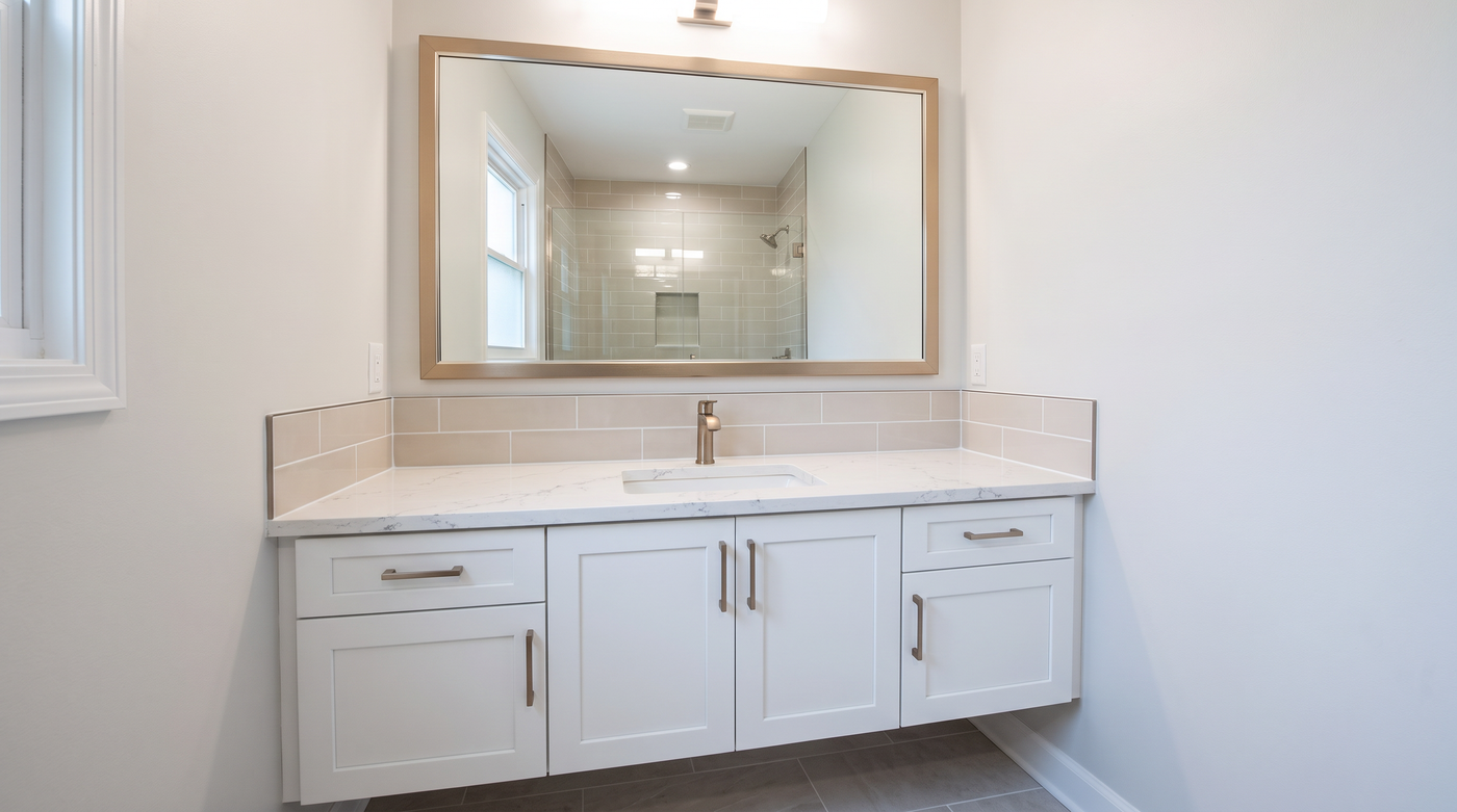 Renovated bathroom with a frame installed over an existing wall mirror