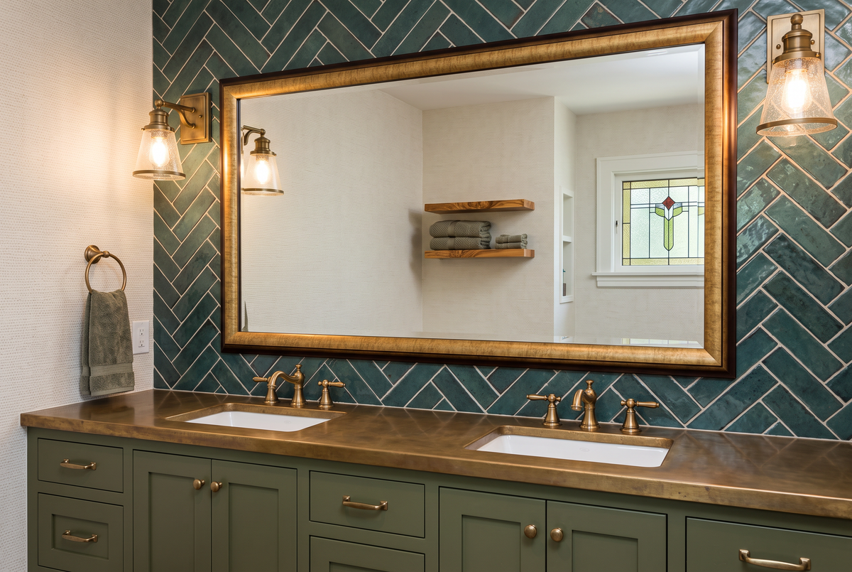 Professionally designed client bathroom with a coordinated framed vanity mirror